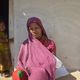 Rani nurses her infant as she waits for a protein feed distributed by the government through a nutrition programme in Surguja district.